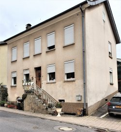 ***SOUS COMPROMIS*** ***SOUS COMPROMIS*** ***SOUS COMPROMIS***

Cette maison ancienne nécessitant de sérieuses rénovations date des années 50, elle comprend un petit jardin et un garage. La maison fait ± 125 m² pour une surface totale de ± 200 m², caves voutées au sous-sol

Le rez de chaussée comprenant salon 17 m² avec insert et une salle à manger ± 14 m², une cuisine équipée ± 10 m² ainsi qu'une salle de douche ± 4 m², la terrasse arrière couverte ± 20 m² avec accès à la buanderie. 

L'étage de nuit est comprend un palier donnant accès à 4 chambres ±10, 12, 14 et 18m².

Un grenier non aménage ± 32 m²

Généralités;

Chaudière au mazout, vitrage simple cadres en bois, tuiles ciment / éternit sur le toit, maison ancienne.

Localisation au centre du village de Mensdorf dans la commune de Bezdorf, proche de l'école fondamentale, la gare de train et des arrêts de bus, à 18 km de la Ville de Luxembourg. Le bien dispose d'une terrasse ± 20 m² couverte, un jardinet avec verrière, un garage fermé. 