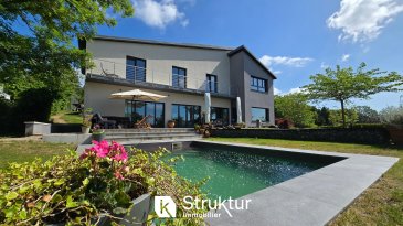 .  +++ EN EXCLUSIVITÉ +++
 +++ Brochure, photos et visite virtuelle sur demande ++
  
 Maison d'exception avec vue panoramique   THIONVILLE GUENTRANGE
  
 Sur les hauteurs prisées de du quartier de Guentrange, laissez-vous séduire par cette superbe maison familiale de 280 m2 habitables complétée par 255 m2 de surface utile en annexe, construite en 2012 sur un terrain de 15 ares clos et arboré. Ici chaque espace a été pensé pour offrir confort lumière et modernité dans un environnement préservé avec une vue imprenable sur Thionville et ses environs
  
 Un cadre de vie rare et privilégié :  Niché dans un secteur calme cette maison offre un parfait équilibre entre tranquillité et proximité de toutes les commodités : commerces, écoles, lycées, centre-ville et accès rapide aux autoroutes A31/A4.
  
 De généreux volumes baignés de lumière :  Dès l'entrée vous découvrirez une pièce de vie spacieuse et lumineuse, le salon, la salle à manger et la cuisine équipée avec îlot central s'ouvrent sur une immense terrasse plein sud de 100 m2, prolongée par le jardin et la piscine.
   Une arrière-cuisine, un salon TV, un bureau, un vestiaire et un wc avec lave-main complètent ce niveau.
  
  
 A l'extérieur le jardin clos et arboré invite à la détente, tout comme la piscine chauffée (2020) équipée d'un système de nage à contre-courant et d'un rideau de sécurité intégré.
  
 Un espace nuit idéal pour toute la famille :  A l'étage la suite parentale offre une chambre, un dressing et une salle de bain privative avec double vasque, douche, baignoire. 3 autres chambres avec dressing aménagé bénéficient d'un accès direct au balcon de 15 m2 offrant une vue panoramique sur la vallée.Deux salles de bains modernes et une buanderie complètent l'étage.
  
  
 le grenier de 80 m2 entièrement aménageable offre un potentiel supplémentaire selon vos projets.
  
  
  
 Le sous-sol dispose d'une pièce aménagée en salle de sport, de plusieurs espaces de stockage, d'un atelier, d'une cave à vin sur terre battue et d'un espace technique regroupant la VMC, le système de chauffage et la filtration de la piscine.
  
   Un garage double motorisé pour deux véhicules et une cour pouvant accueillir jusqu'à six voitures.
  
  
 Modernité et performance énergétique
   DPE B/A
 Une maison rare pensée pour le confort et le bien-être
 Cette propriété au design intemporel et aux prestations soignées n'attend que vous pour écrire une nouvelle histoire
  
  
 Caractéristiques :
  
 - DPE B/A
 - Consommation énergétique réelle 2024 : +/-2600 EUR (Electricité +/-2100 EUR et +/- 500 EUR de Bois de chauffage)
  
 - Isolation par l'extérieur 14cm, Poêle à bois avec répartiteur de chaleur, Puit Canadien, VMC double flux, Chauffage électrique par le sol, Fenêtres oscillo-battantes bois/alu, triple vitrage à isolation renforcée
 - Vitrage anti effraction au rez-de-chaussée
  
 - Volets brise soleil orientable motorisés
  
 - Toiture en Zinc (2021)
  
 - Cuisine équipée avec ilot  
  
 - Salle de bains meublées avec radiateur porte-serviettes
  
 - Piscine (2020) avec nage à contre-courant et chauffée par pompe à chaleur, filtration à sable
  
 - Dressings aménagés avec penderies et étagères
  
 - Suite parentale avec double vasque, baignoire, douche, radiateur porte serviette et dressing
  
  
 - Les possibilités d'aménagement : Création d'une suite parentale au rez-de-chaussée, aménagement partiel du sous-sol en studio
  
 -
  
  
 DPE B/A
  
 Estimation des coûts annuels : entre 1 960 EUR et 2 700 EUR par an
  
 Prix moyens des énergies indexés sur les années 2021, 2022, 2023