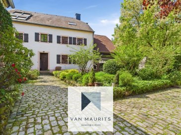 Magnifique ferme de 1829, entièrement rénovée avec passion durant les dernières années, qui est érigée sur le terrain de 8a34ca et qui dispose d'une surface habitable de ± 303 m² pour une surface totale ± 446 m². Les propriétaires ont eu le bon goût de garder des éléments d'époque en modernisant la maison et la grange attenante. Le portail électrique s'ouvre sur la partie cour et jardin communiquant avec la grange d'un côté et de l'autre avec la maison principale, laquelle se compose comme suit :

Le rez-de-chaussée :

Le hall d'entrée dessert un premier salon/salle à manger de ± 16m², un salon principal sur deux niveaux de ± 42m² avec une mezzanine de ± 27m², une cuisine séparée et équipée de ± 18m² avec un cellier de ± 12m², une salle de douche de ± 8 m² et un débarras.

Le premier étage :

Un hall de nuit de ± 8 m² mène vers 3 chambres de ± 15, 16 et 20 m² ainsi qu'une salle de bain de ± 11 m².

Les combles récemment aménagés et rehaussés forment un magnifique espace ouvert avec une hauteur sous plafond de 4,5 m. S'y trouvent actuellement une suite parentale avec un coin bureau, une salle de bain et un dressing, le tout de ± 92 m².

La grange attenante dispose d'une surface totale de ± 143 m² répartie comme suit: un garage de ± 93 m², ainsi que 2 pièces multifonctionelles de ± 25 et 26 m². Elle est aujourd'hui utilisée comme garage, espace hobby, chaufferie et buanderie.

Généralités :

- Bien rare;
- Maison entièrement rénovée;
- Situation calme, près de la nature;
- Plusieurs possibilités d'aménagement et d'exploitation;
- Propriété rare avec tout le confort, prête à accueillir immédiatement une famille.

Agent responsable : Katia Gravière au 661 33 29 82 ou katia@vanmaurits.lu