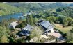 Maison Vente 5 chambres à Bonnal - 1 950 000 € Texte français ci-dessous.
Eines der traumhaftesten Anwesen im Luxemburger Land.
Auf einer Anhöhe, direkt über dem Stausee und grandiosem Rundumblick, liegt das Anwesen sehr ruhig und mitten in der Natur. Nur ein kleiner Weg führt zu der handvoll, exklusiven Häuser, in einer sehr bevorzugten Lage.
Das Haupthaus wurde 1960 im Ardennen-Stil errichtet, vom jetzigen Eigentümer von Grund auf erneuert und mit einem 450m2 großen, modernen Anbau erweitert. Somit stehen insgesamt fast 517m2 Wohnfläche zur Verfügung und eine riesige Garage für mindestens 4 Autos.
Das ursprüngliche Haus wurde komplett erneuert, wobei der klassische Ardennen-Stil berücksichtigt blieb. Es wurden nur die besten Materialien verwendet und gerade im Detail keinerlei Kosten gescheut. So entstand im unteren Bereich ein großzügiges Wohn/Esszimmer mit Zugang zur wunderschönen, riesigen Terrasse mit Seeblick. Die Küche ist funktionell/modern und mit einer Durchreiche mit dem Esszimmer verbunden. Des Weiteren gibt es eine Gäste-Toilette und eine klassische Treppe in den ersten Stock. Dort liegt das Master-Schlafzimmer mit Balkon (Traumblick), eigenem Traum-Bad und Dressing. Daneben gibt es ein weiteres Zimmer mit Schlafzimmer im Stock darüber. Hier gibt es einen Zugang zur Sonnenbank. Weiterhin findet man ein Abstellzimmer, ein Bad, eine separate Toilette und ein gemütliches Zimmer, dass als Büro genutzt werden kann. Hier liegt auch der Zugang zum neuen Teil des Anwesens. Man betritt einen Raum von ca 70m2, mit 4 großen Fenstern und einem weiteren, offenen Stockwerk, welches nochmals 25m2 umfasst. Im hinteren Teil gelangt man über eine Glas-Schiebetür in einen modernen Dressing und ein sehr modernes Bad mit Dusche und Toilette. Dieser großzügige Bereich eignet sich zum sehr komfortablen Wohnen, als Büro oder seriösen Hobby-Raum. Eine weitere Tür öffnet den rechten Flügel des Anwesens. Hier liegen ein großer Raum mit Kamin und tollen, burgähnlichen Fenstern, sowie ein weiterer großer Raum mit Badezimmer. Man kann diesen Bereich auch getrennt vom Haupthaus, von der Garagenseite erreichen. Eine weitere Treppe führt in den 2.Stock des rechten Flügels und bietet ein wahnsinniges Turmzimmer mit einem 2.Bereich, der als Abstellkammer oder Archiv genutzt werden kann. Von hier hat man einen unglaublichen Blick über den Stausee und die gesamte Natur. Diese Räumlichkeiten des rechten Flügels können als eigenständige Wohnung oder als Büro genutzt werden. Im Erdgeschoss dieser Seite des Anwesens befinden sich die riesige Garage für mindestens 4 Autos, einer Werkstatt, ein Badezimmer mit Dusche und die super-moderne Gas-Heizungsanlage. Eine Regenwasseranlage ist vorinstalliert.
Alle verbauten Materialien sind sehr hochwertig, alle Holzarbeiten, Kacheln, Marmor und Steingut, Fenster ( im neuen Teil 3-4 fach ), Fliegengitter, Schieferdächer, Isolierungen, Alarmanlage, Garagentore etc.
Auf die Außenanlage des Anwesens wurde besondere Rücksicht genommen. Über einen eigenen Weg gelangt man auf das riesige Grundstück mit stilgerechter Vorfahrt vor dem Haus. Der vordere Teil des Anwesens wurde mit viel Liebe zum Detail angelegt und begeistert alle Besucher. Eine riesige Durchfahrt vor den Garagen stellt eine praktische Verbindung zur Terrasse und Garten dar oder sorgt dafür, dass man bei jedem Wetter trocken ins Haus kommt, ohne die Garage benützen zu müssen. Der Eingangsbereich des ursprünglichen Hauses wurde nach toskanischem Vorbild ausgebaut mit einer romanischen Pergola mit Platz für viele Freunde und einem eigens gebauten Backofen/Grill Häuschen. Hier lassen sich die Sommertage wie in Italien verbringen. Eine weitere, riesige Terrasse befindet sich hinter dem Anwesen und lässt sich , unter anderem, vom Wohnzimmer her betreten. Hier wurde sehr stilvoll mit vielen Steinen gearbeitet, mehrere luxuriöse Aufenthaltsmöglichkeiten erschaffen, sowie eine traumhafte Gartenlandschaft gestaltet. Verrückte Details sind 2 Außenkamine, Lampen in verschiedenen Nischen und viele verrückte Accessoires an den Wänden und im Garten. Hier finden sich weitere kleinere Gebäude, wie zum Beispiel eine Holz-Chalet (30m2), ein großer Hundezwinger, ein Abstellhäuschen für Gartengeräte, und ein professionelle Umweltkontainer.
Das Grundstück verläuft sich auf der rechten Site des Anwesens in einem riesigen, zum Teil angelegten ,Park mit eigenem Zugang von der unteren Straße. Hier gibt es wiederum mehrere kleine Holzschuppen, eine Werkstatt und die Möglichkeit ein großes, weiteres Gebäude zu errichten. ( z.B. einen großen Pferdestall für mehrere Tiere, eine große Werkstatt oder einfach nur eine Halle für verschiedene Möglichkeiten). Das gesamte Anwesen ist eingezäunt.
Das Anwesen ist einzigartig in der Lage, Größe und Qualität, was heutzutage kaum noch realisierbar sein wird. Umgeben von weiteren Traumhäusern und prominenter Nachbarschaft, lässt sich Natur und die absolute Ruhe genießen.
Insenborn liegt malerisch am Stausee von Luxemburg, mitten in der Natur. Der See bietet viele Wassersportmöglichkeiten und der Strand von Insenborn ist in ein paar Minuten erreichbar. Das Städtchen Esch/Sur liegt nur einige Kilometer entfernt. Arlon (B) befindet sich 20 Minuten auf der anderen Seite des Sees, sowie eine Autobahnanbindung Luxemburg-Brüssel. Die Verbindung zur Stadt Luxemburg wurde durch die Eröffnung des Stafelter Tunnels noch einfacher. Den Kirchberg/Flughafen erreicht man in etwa 40 Minuten.
Une des plus belles propriétés de rêve au Luxembourg.
La propriété a une situation très tranquille sur un coteau en pleine nature, directement au-dessus du lac de barrage et offrant une vue panoramique grandiose. Seulement quelques maisons exclusives en situation très privilégiée sont accessibles par un seul petit chemin.
La maison principale de style ardennais, a été érigée en 1960. Elle a été rénovée de fond en comble par le propriétaire actuel et elle a été agrandie d’une annexe moderne de 450m2. Par conséquent, presque 517m2 de surface habitable, ainsi qu’un garage gigantesque pour au moins 4 voitures sont à disposition.
Lors de la rénovation complète de la maison initiale, le style classique ardennais a été respecté. Seulement les meilleurs matériaux ont été utilisés et, surtout en détail, on y a mis le prix. Il en résulte dans la partie inférieure, un salon/salle à manger spacieux avec accès sur la terrasse magnifique et gigantesque avec vue sur lac. La cuisine est fonctionnelle et moderne et est reliée par un passe-plat à la salle à manger. En outre, on a un WC séparé et un escalier classique pour atteindre le premier étage où se situe la chambre à coucher principale avec balcon et vue de rêve, ainsi qu’un dressing et une salle de bains de rêve. A côté, on trouve une pièce supplémentaire avec chambre à coucher au-dessus. Ici on a accès au solarium. En outre, cet étage est équipée d’ un débarras, d’une salle de bains, d’un WC séparé et d’une chambre douillette, qui peut avoir l’affectation de bureau. Ici se trouve l’accès à la nouvelle partie de la propriété. On entre dans une pièce de +/- 70m2, équipée de 4 grandes fenêtres et d’un étage ouvert supplémentaire, qui englobe encore une fois 25m2. Dans la partie postérieure, on accède par le biais d’une porte coulissante en verre à un dressing moderne et une salle de bains moderne avec douche et WC. Cette partie généreuse s’apprête particulièrement comme séjour confortable, comme bureau ou comme spacieuse pièce à hobby. Une porte supplémentaire ouvre l’aile droite de la propriété où se situe une grande pièce avec cheminée équipée de fenêtres dans le style d’un château-fort, ainsi qu’une autre grande pièce avec salle de bains. Toute cette partie peut également être accédée séparément à partir du côté du garage. Un escalier supplémentaire mène au 2me étage de l’aile droite et offre une chambre-tour délirante avec une 2me partie, qui peut être utilisée comme archive ou débarras. D’ici, on a une vue incroyable sur la nature et le lac. Ces locaux de l’aile droite peuvent être exploités comme bureau, ou comme appartement séparé. Au rez- de- chaussée de ce côté de la propriété se situe l’énorme garage pour au moins 4 voitures, un atelier, une salle de douche et le chauffage au gaz super-moderne. Une installation de récupération des eaux pluviales est préinstallée. Tous les matériaux de construction, comme la menuiserie, le carrelage, marbre, fenêtres (dans la nouvelle partie à triple et quadruple vitrage),Moustiquaires, isolations, installation d’alarme, portes de garage etc., sont de très haute qualité.
Les alentours de la propriété ont été pris particulièrement en considération. Par le biais d’un chemin privé, on atteint le terrain gigantesque avec arrêt de style devant la maison. La partie antérieur de la propriété a été aménagée avec beaucoup d’amour au détails et enthousiasme tous les visiteurs. Le passage gigantesque devant les garages constitue un raccordement pratique avec la terrasse et la jardin, de sorte qu’on peut atteindre la maison par tous les temps sans devoir utiliser le garage.
La partie d’entrée de la maison initiale a été aménagé selon le modèle toscane avec une pergola romantique, une maison à barbecue avec four, pour avoir beaucoup d’espace pour les invités. Les journées d’été se passent comme en Italie. Une autre terrasse gigantesque se situe dans la partie postérieure de l’immeuble et peut être atteinte entre autres à partir du living. On a travaillé beaucoup de pierres, crée plusieurs possibilités luxurieuses de séjour et dessiné un jardin de rêve.
En détail, on trouve 2 cheminées extérieures, des lampes dans diverses niches et beaucoup d’accessoires délirants sur les murs et au jardin. Plusieurs petites bâtisses se trouvent ici, comme un chalet en bois de 30 m2, un chenil, un abri de jardin pour outils et un conteneur environnemental professionnel.
Le terrain se perd du côté droit en un parc énorme en partie aménagé avec accès séparé de la rue inférieure. On y trouve encore plusieurs remises en bois, un atelier et la possibilité d’ériger un grand immeuble supplémentaire. (p.ex. écurie pour plusieurs chevaux, un hall ou un atelier) Toute la propriété est clôturée.
Cette propriété est unique depuis sa situation, sa surface et sa qualité, dont la réalisation nos jours ne semble pratiquement plus possible. Entouré d’autres villas de rêve et voisinage élitaire, la nature et le calme absolu peuvent être savourés.
Insenborn se situe de façon pittoresque en pleine nature au bord du lac de barrage au Luxembourg. Le lac offre beaucoup de possibilités de sports nautiques et la plage d'Insenborn est à quelques minutes. Le petite ville d'Esch- sur- Sûre n'est qu'à quelques kilomètres. Arlon se situe à 20 minutes de l'autre côté du lac, ainsi qu'un accès sur l'autoroute Luxembourg - Bruxelles. Le trajet vers Luxembourg, Kirchberg et l'aéroport va considérablement s'améliorer avec l'ouverture de la route du nord .