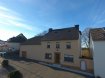 Maison individuelle Vente 3 chambres à Wahlhausen - 628 000 € Jolie petite ferme construite dans les années 1900, offrant une surface habitable de +/- 200 m2, au centre du petit village de Wahlhausen, qui se situe à quelques minutes du centre scolaire et du centre acquatique 'Parc Hosingen' et de la N7 vers Luxembourg.
La maison se compose comme suit:
Sous-sol: grande cave de 24.25 m2
Rez-de-chaussée: hall d'entrée, living, salle à manger, cuisine équipée neuve, débarras et WC séparé
1er étage: hall avec espace bureau, 3 chambres à coucher et salle de bains
Combles: vaste grenier de 66 m2
Un grand garage (41.32 m2), une étable (38.25 m2), une grange (26.80 m2) ainsi que la chaufferie sont annexés à la maison.
Possibilité d'aménager le grand espace ouvert en-dessus du garage ou de le transformer en habitation d'une surface totale de +/- 90 m2.
Plusieurs emplacements de stationnement se trouvent devant la maison.
La maison est disponible de suite.
Ref agence :1225